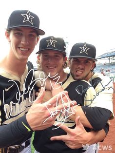 three baseball players posing for a photo with their hands in the air and one holding his hand out