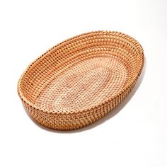 a round woven basket sitting on top of a white table