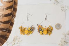 Flower circle dangle earrings. In yellow/ochre and grey colours. Can be used for weddings, other events or just everyday use. The earrings are made of preserved flowers, leaves and grass, wire, and other trinkets used for arranging :) Diameter: 6cm (2.5 inches) - weight 8-10g, length 8cm or 3cm (1.2 inches) - they weight only 5-8g. :) Please choose the material: 1. GOLD IMITATION HOOK (golden imitation wire/circle + golden imitation hook) 2. SURGICAL STEEL HOOK (silver imitation wire + surgical Yellow Flower-shaped Hoop Earrings Gift, Yellow Flower Hoop Earrings For Gift, Yellow Flower Shaped Hoop Earrings As Gift, Yellow Dangle Earrings For Wedding, Handmade Yellow Flower Earrings For Wedding, Yellow Flower Drop Earrings For Wedding, Yellow Flower Decoration Earrings As Gift, Yellow Earrings With Flower Decoration, Yellow Earrings With Flower Decoration For Gift