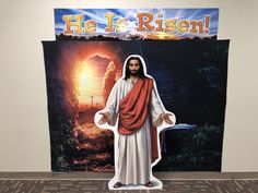 a cardboard statue of jesus in front of a banner