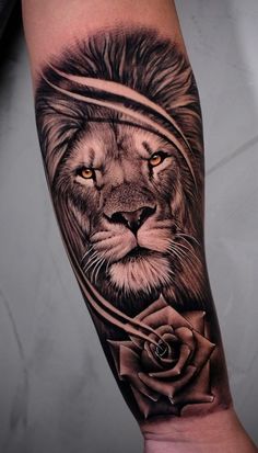 a man's arm with a lion and rose tattoo design on the left forearm