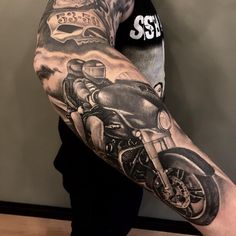 a man with a motorcycle tattoo on his arm