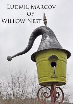 a yellow birdhouse with a long tail on it's head and the words lummi marcv of willow nest above it