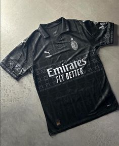 a black soccer jersey laying on the ground