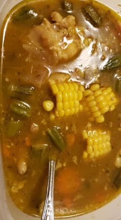 a plastic container filled with soup and vegetables