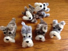 several small stuffed animals sitting on top of a wooden table next to eachother