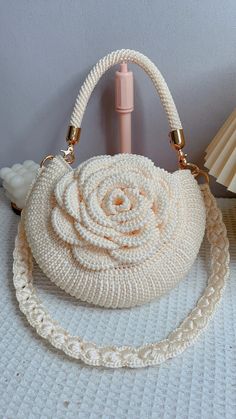 a white purse sitting on top of a table