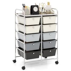 a metal cart with several bins and a clock on the top one is white