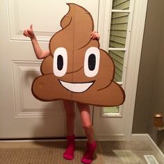 a person wearing a poop costume standing in front of a door