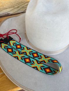 Handmade hatband! Handmade Southwestern Multicolor Hat Band, Custom Hat Bands For Rodeo, One Size Fits Most, Handmade Multicolor Hat Bands For Rodeo, Handmade Artisan Hat Bands For Western-themed Events, Adjustable Multicolor Ranch Hats, Artisan Hat Band With Flat Crown For Festivals, Artisan Multicolor Hat Bands For Country Events, Custom Adjustable Hat Bands For Festivals, Handmade Adjustable Hat Bands For Rodeo