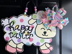 a door hanger with a happy easter sheep design on it's front door