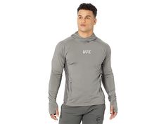 UFC Long Sleeve Pullover Hoodie - Men's Clothing : Pewter : Keep yourself at ease wearing the UFC Long Sleeve Pullover Hoodie that protects the back of your hands with elongated sleeves. Hooded design. Pull-over style. Long sleeves. Two zippered side pockets. Brand name detailing on the front. 90% polyester, 10% elastane. Machine wash, tumble dry. Imported. Measurements: Length: 28 in. Measurements: Length: 28 in Product measurements were taken using size MD. Please note that measurements may va Gray Functional Hoodie For Sports, Functional Gray Sports Hoodie, Gray Functional Sports Hoodie, Gray Hoodie For Winter Sports, Heather Grey Long Sleeve Sports Hoodie, Gray Winter Sports Hoodie, Gray Winter Hoodie For Light Sports, Gray Long Sleeve Hoodie For Casual Sports, Reebok Hoodie