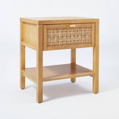 a small wooden table with a drawer on one side and a shelf on the other