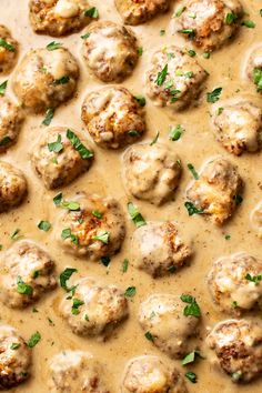 meatballs covered in gravy and garnished with parsley