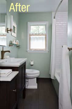 a white toilet sitting next to a bath tub in a bathroom under a sink mirror