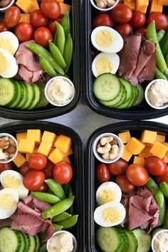 four plastic trays filled with different types of vegetables and meat on top of each other