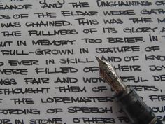 a fountain pen is laying on top of a piece of paper that has writing on it