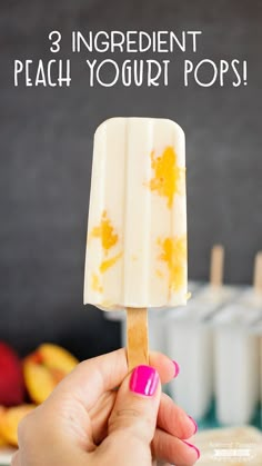 a hand holding an ice cream popsicle with the words 3 ingredient peach yogurt pops