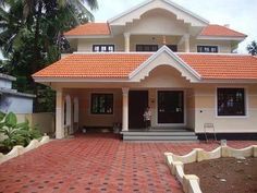 a white and orange house sitting on top of a lush green field