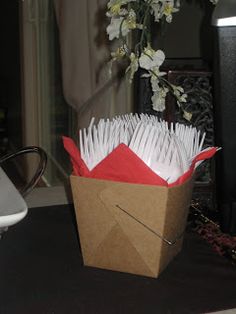 a brown box filled with papers next to a laptop computer on top of a table