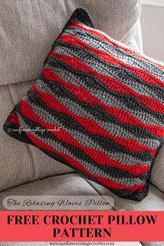 a crocheted pillow sitting on top of a couch next to a gray chair