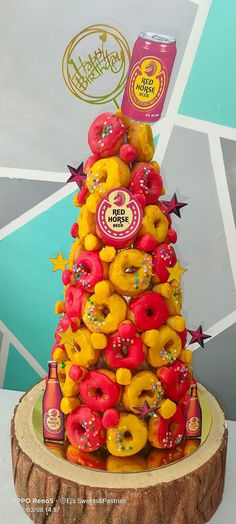 a cake made to look like a tree with donuts and drinks on the top