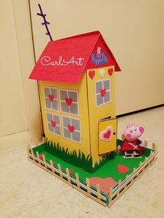 a paper model of a house with pep the pig on it