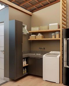 a washer and dryer in a room with wood flooring on the walls