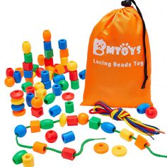 an orange bag filled with lots of colorful plastic beads next to a drawstring bag