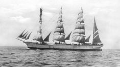 an old photo of a sailing ship in the ocean with sails down and three masts