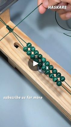 someone is making something with beads and string