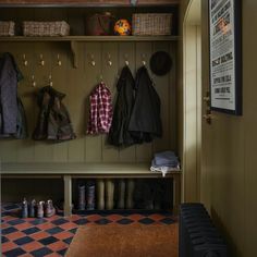 the coat rack is full of coats and shoes, along with other items on display