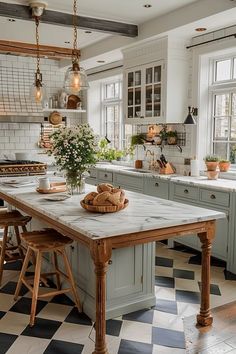 a kitchen with checkered flooring and an island in front of the stove top