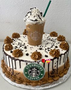 there is a starbucks cake with whipped cream and chocolate sprinkles on it