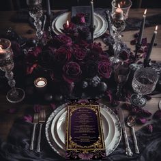 the table is set with candles, plates and menus for an elegant dinner party