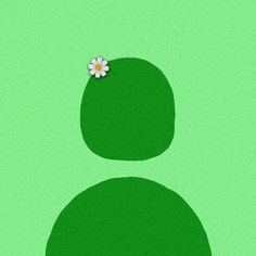 a flower is placed on the top of a green piece of grass with two circles