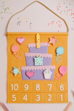 a colorful birthday card on top of a table with confetti and decorations around it