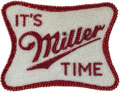 a red and white pillow with the words it's miller time embroidered on it