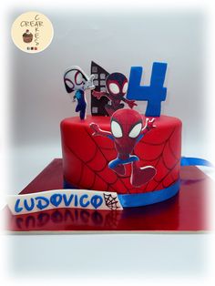 a spiderman cake with the number four on it and some decorations for him to decorate