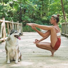 a woman is doing yoga in the woods