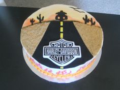 a motorcycle themed birthday cake on a black counter top with the name harley davidson written on it