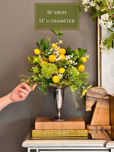 Delightful centerpiece arrangement of faux lemon tree branches, white Baby's breath blossoms, green berry clusters, delicate greenery and trailing vines. This is a *One of a Kind* arrangement made in a vintage antique silver vase. Once it is sold - it will never be offered again :) Handmade by me - just for you! Perfect in a sunny kitchen or any corner that needs a little summertime joy. Approximate size: 16" high 13" in diameter *Please see my shop for the other nearly-natural floral arrangements, exquisite floral stems and unique greenery: https://www.etsy.com/shop/IntoTheOrchard Faux Lemon Tree, Tall Centerpiece, Sunny Kitchen, Tall Centerpieces, Silver Vase, Lemon Tree, Artificial Flower Arrangements, Nearly Natural, Baby's Breath