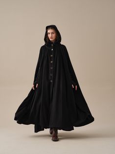 "This wool claok from Linennaive will add an elegant finishing touch to any ensemble. Crafted from soft wool, this vintage-inspired cloak designed in a loose, enveloping silhouette that layers comfortably over anything from tailoring and chunky knits to foundational pieces. The large pockets and hood are practical and convenient, the pleated details are elegant and romantic.this casual piece for any occasion will make you the center of attention. If cold windy mornings are your kryptonite, then this single-breasted cloak is made for you. Wearing this cloak, imagine the foggy sky outside the window, Snow covering the ground. Santa Claus is coming in his sleigh. 【Fabric】 80% wool; 20% Polyester 550g/gram Length 132-135 cm 1)THE MOST DURABLE We use only the longest fibers, averaging 39-42mm l Modern Cloak Outfit, Woman In Cloak, Mage Clothing, Hooded Cloak Pattern, Cloak Fashion, Witch Cloak, Cloak Outfit, Cloak Pattern, Wool Cloak