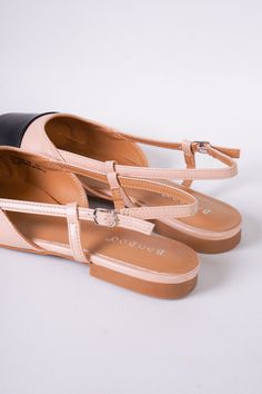 The Imperial Flats are polished tan and black flats that exude sophistication and style! The graceful almond shaped toe and slingback strap with a buckle closure give a sleek elevated look, making these flats a staple for any wardrobe. They fit true to size and are made of man made materials. Black Flats, Sleek, Buckle, Black