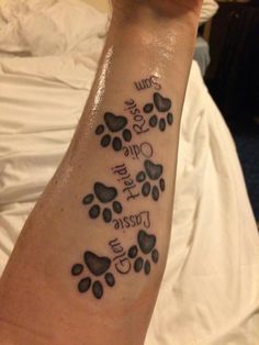 a person with a tattoo on their arm that says you are one and two dogs