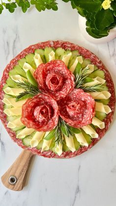 a platter with flowers and meat on it