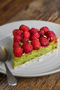 a piece of cake with raspberries on top