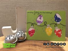 a card with three ornaments on it next to an egg holder and two eggs in the shape of hearts