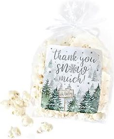 a bag filled with white chocolate covered in marshmallows and the words thank you snow much