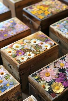 several wooden boxes with painted flowers on them